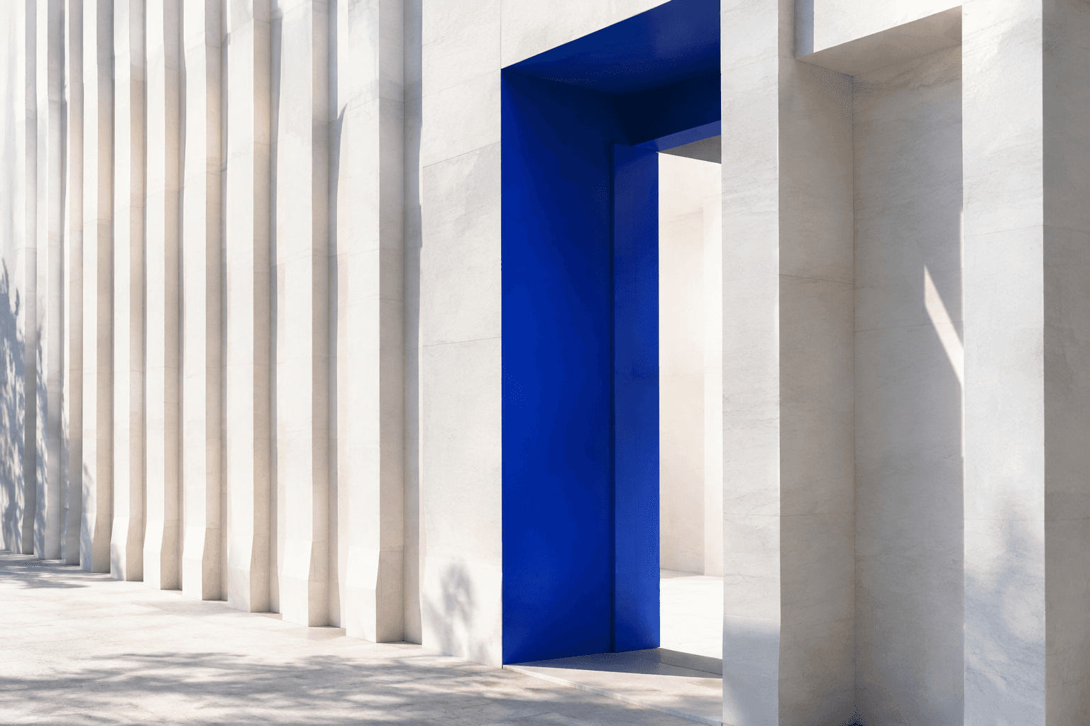 Conceptual architecture with layered white stone fins and a blue doorway